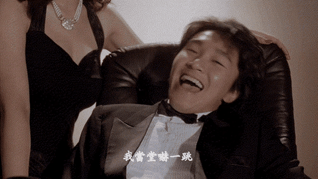 a man in a tuxedo is laughing next to a woman in a dress