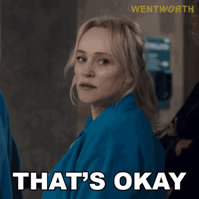 a woman in a blue shirt with the words that 's okay on it