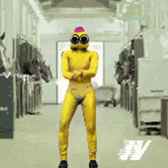 a person in a yellow suit is standing in a hallway