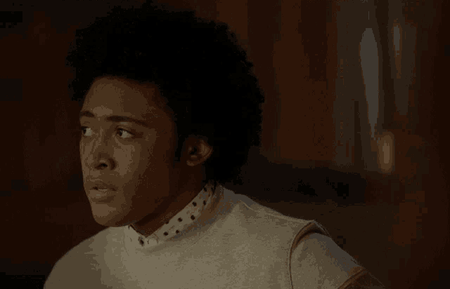 a close up of a man 's face with his eyes closed in a dark room
