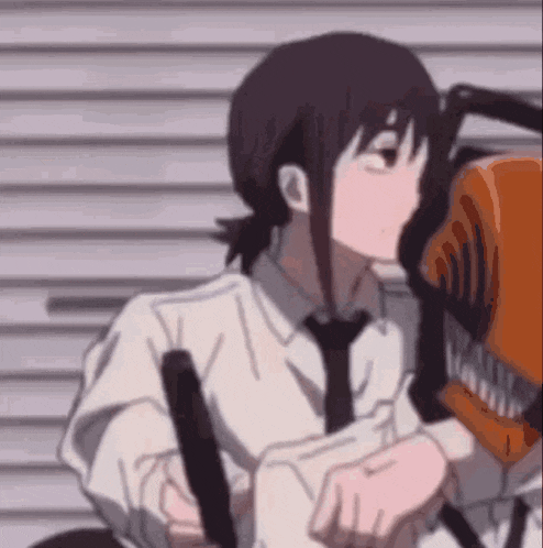 a close up of a person holding a chainsaw in their hands .