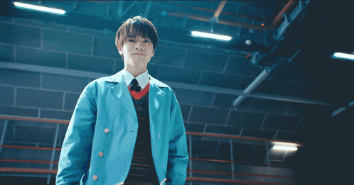 a young man in a blue jacket and red tie