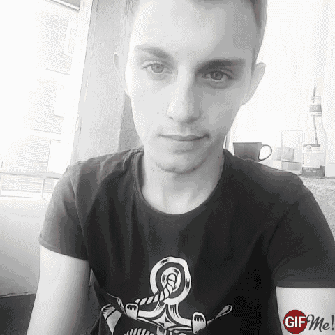 a black and white photo of a young man wearing a t-shirt that says gif me on it