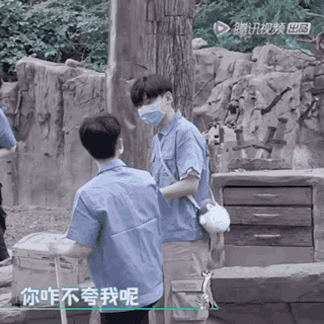 a man wearing a mask stands next to another man