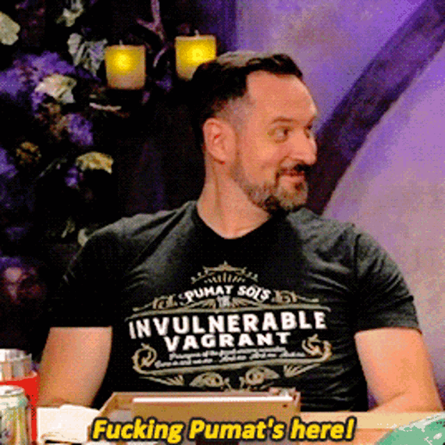 a man wearing an invulnerable vagrant t-shirt says fucking pumat 's here