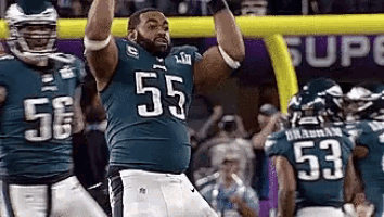 a football player with the number 55 on his jersey celebrates