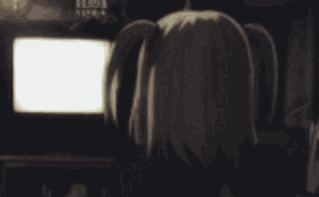 a girl with pigtails is looking at a tv screen with a white screen