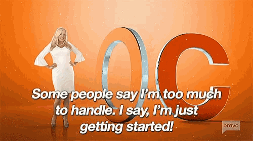 a woman in a white dress is standing in front of a large orange letter c ..
