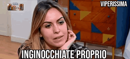 a woman is sitting in front of a dresser with the words inginocchiate proprio written on the bottom
