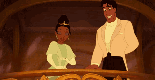 a man and a woman are standing on a balcony and smiling