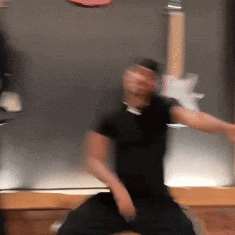 a blurry picture of a man in a black shirt playing a guitar