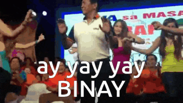 a man is dancing in front of a crowd and the words ay yay yay binay are visible