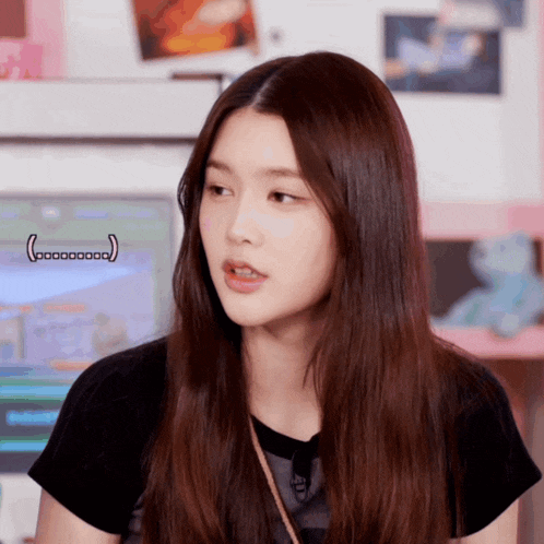 a woman with long brown hair is wearing a black t-shirt that says ' i love you ' on it