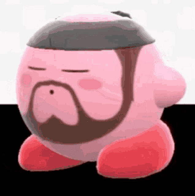 a pink kirby with a beard and mustache is standing on a table .