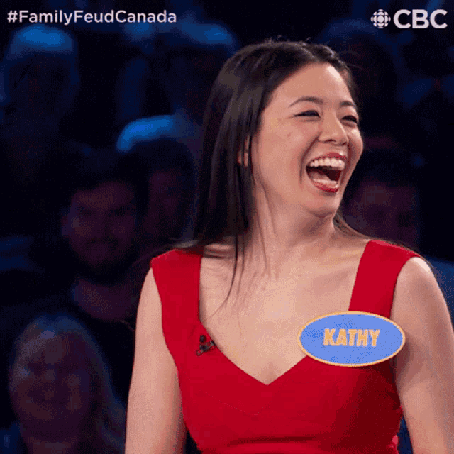 a woman in a red dress with kathy written on her name tag