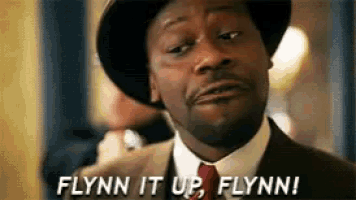 a man in a suit and tie is saying flynn it up flynn !
