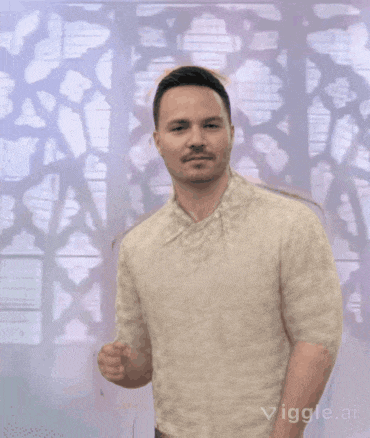 a man with a mustache is standing in front of a wall with a pattern on it .