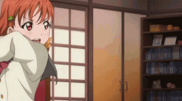 a girl with a flower in her hair is standing in a room with a bookshelf
