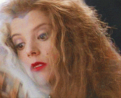 a close up of a woman with long hair and red lips