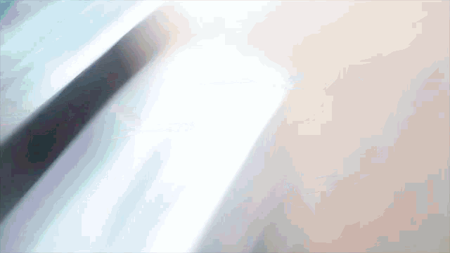a blurry picture of a person 's ear with a light shining through it