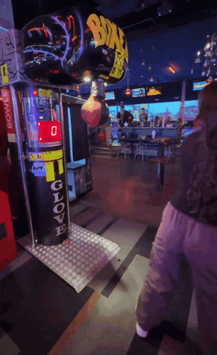 a woman is playing a game called gloves