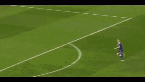 a soccer player with the number 12 on his back is laying on the ground