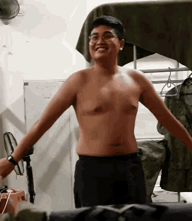 a shirtless man is standing in front of a white board that says 45-4am