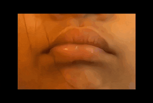 a close up of a person 's face with a black background