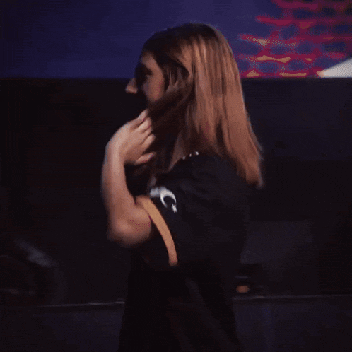 a woman in a black shirt with the letter g on the arm