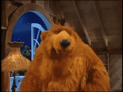 a bear with a birthday cake and the word suprise