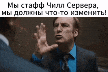 a man in a suit and tie is making a funny face