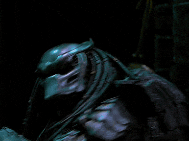 a blurry picture of a person standing in a dark room with a few lights behind them