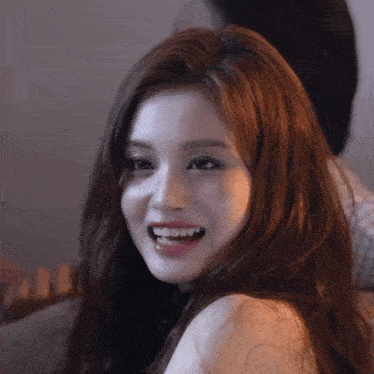 a close up of a woman 's face with a smile on her face