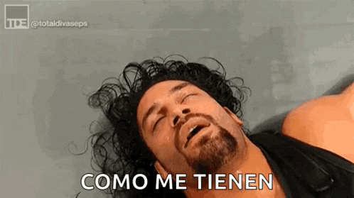 roman reigns is laying down with his eyes closed and saying `` como me tienen '' in spanish .