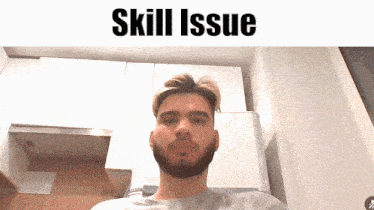 a man with a beard is looking at the camera with the words skill issue behind him