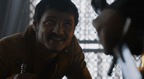 a man with a mustache is smiling and looking up at something