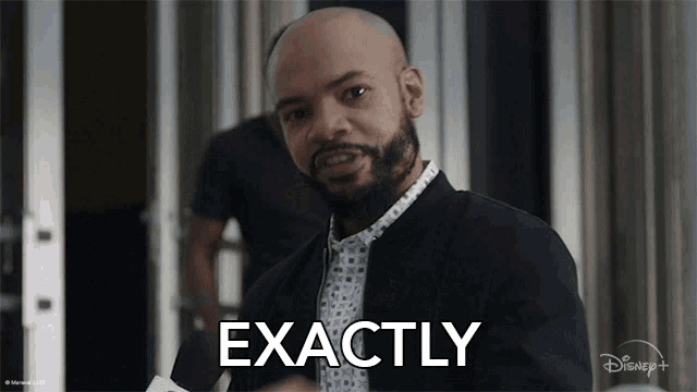 a man with a beard says exactly in front of a disney logo