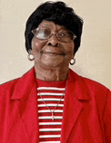 an elderly woman wearing glasses and a red jacket is smiling for the camera .