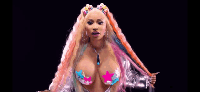 a woman with colorful hair and a necklace is wearing a very revealing top .