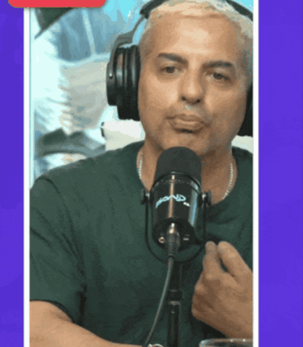 a man wearing headphones is speaking into a microphone that says ' ford ' on it