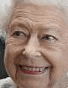 an elderly woman with white hair is smiling for the camera .