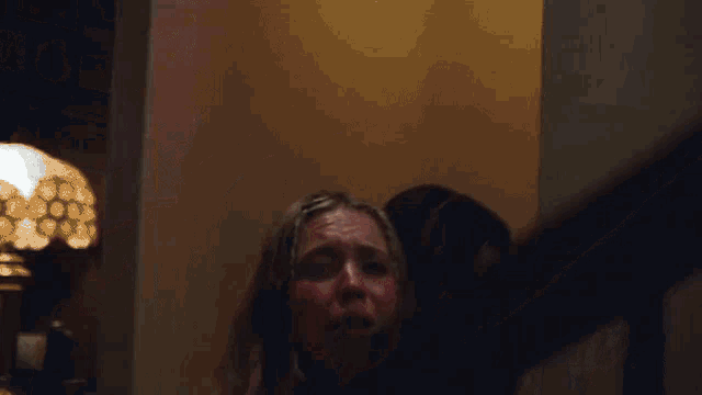 a woman in a pink bikini is being held by another woman on the stairs
