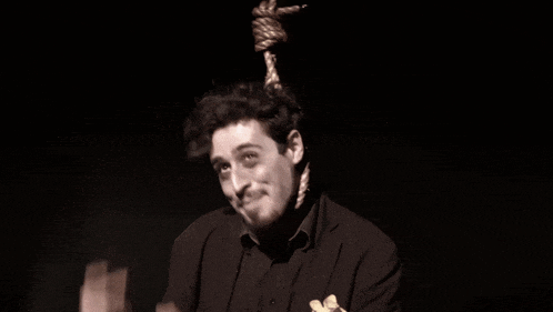 a man with a rope hanging from his head making a face