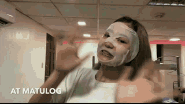a woman with a mask on her face and the words " at matulog " on the bottom