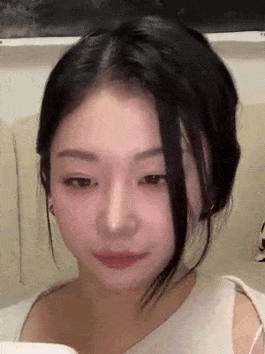 a close up of a woman 's face with her eyes closed and her mouth open .