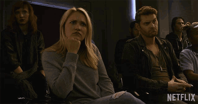 a group of people sitting in a room with a netflix logo in the corner