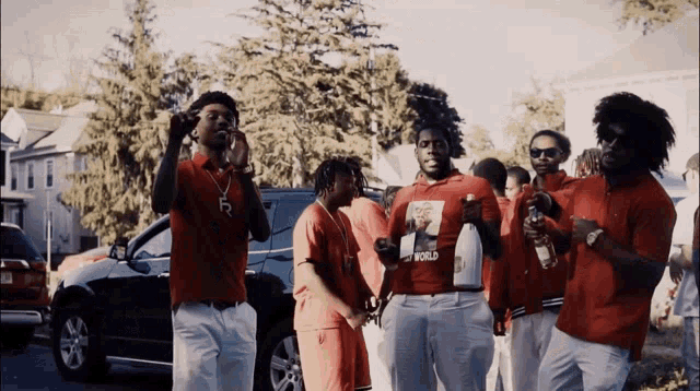 a group of men wearing red shirts one of which says world