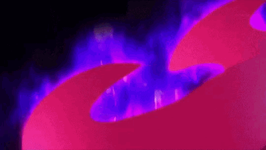 a close up of a purple and pink background with a purple flame coming out of it