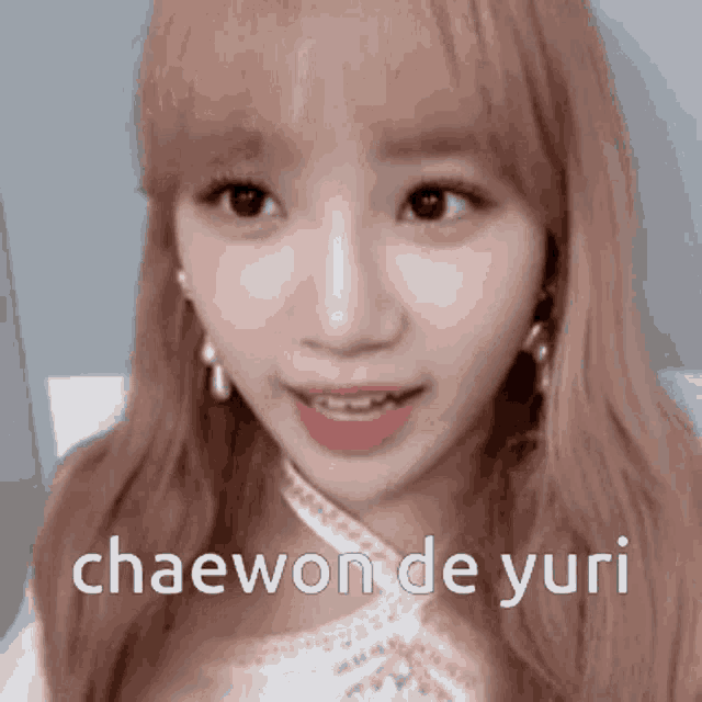 a close up of a woman 's face with the words chaewon de yuri above her