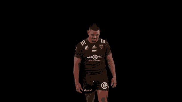 a man wearing a black and green adidas pro pro jersey